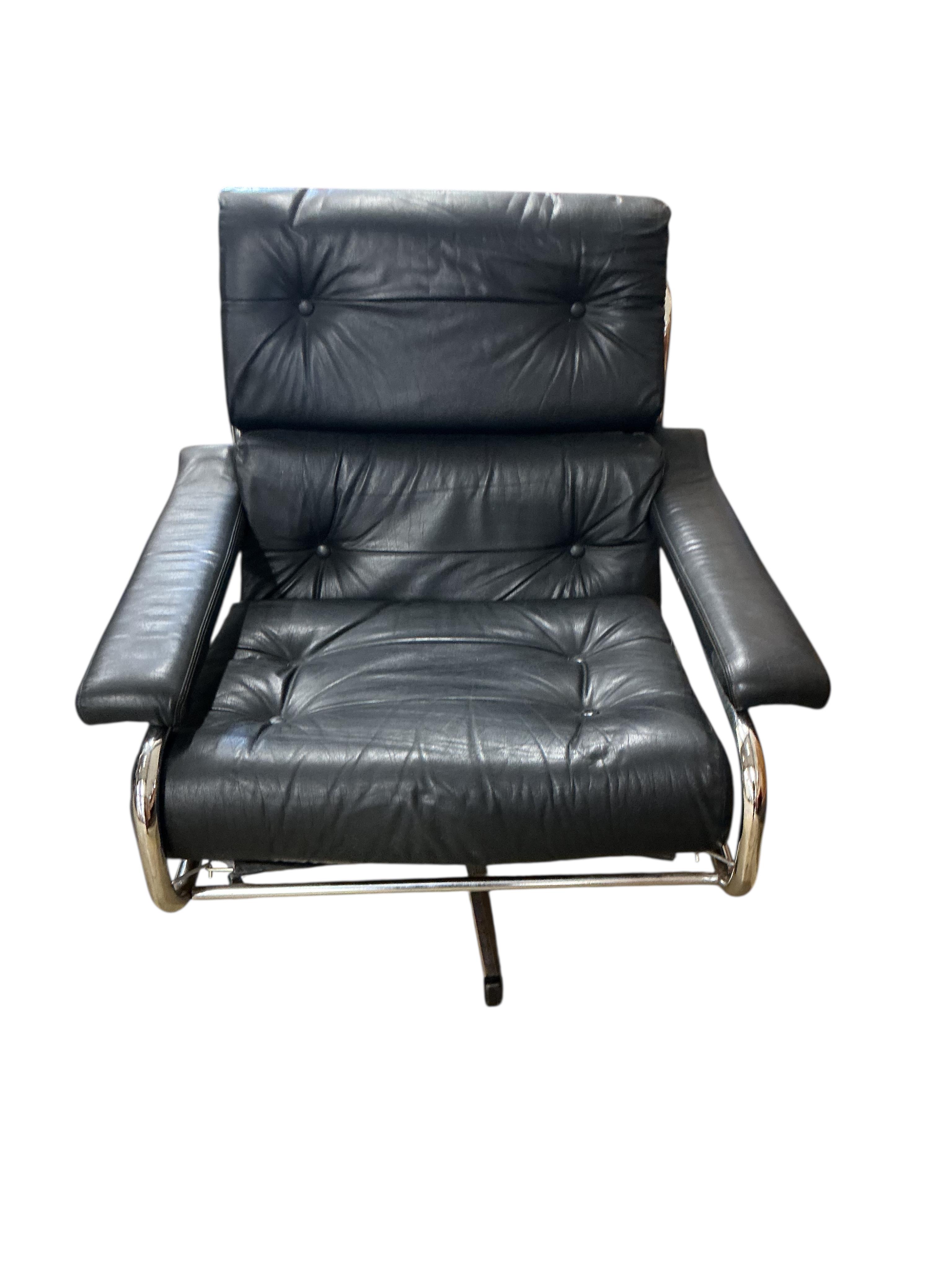 A near pair of mid century Pieff black and green leather swivel lounge chairs on chrome five prong bases, width 86cm, depth 94cm, height 91cm, one with a footstool